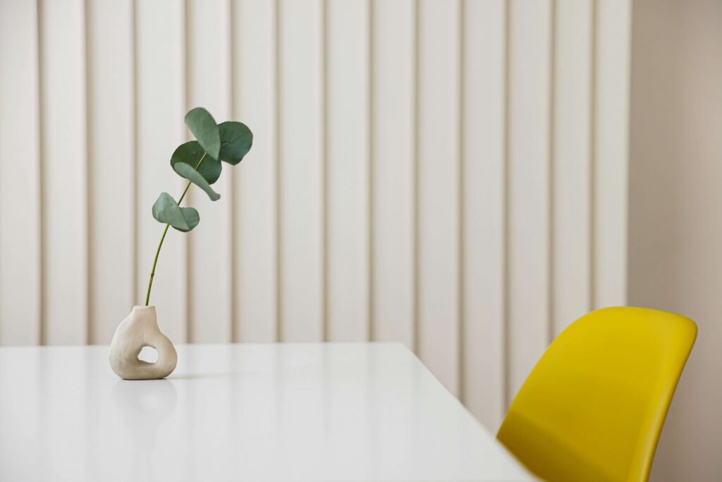 Yellow Chair | individual therapy in los angeles, ca | asian american therapist in los angeles | online therapy in los angeles, ca | adhd treatment in los angeles, ca | 90404 | 90503 | 90071 Shows an empty room with a plant in a vase on a table with a yellow chair. Represents how Yellow Chair Collective can support you with an asian american therapist in los angeles and individual therapy in los angeles, ca