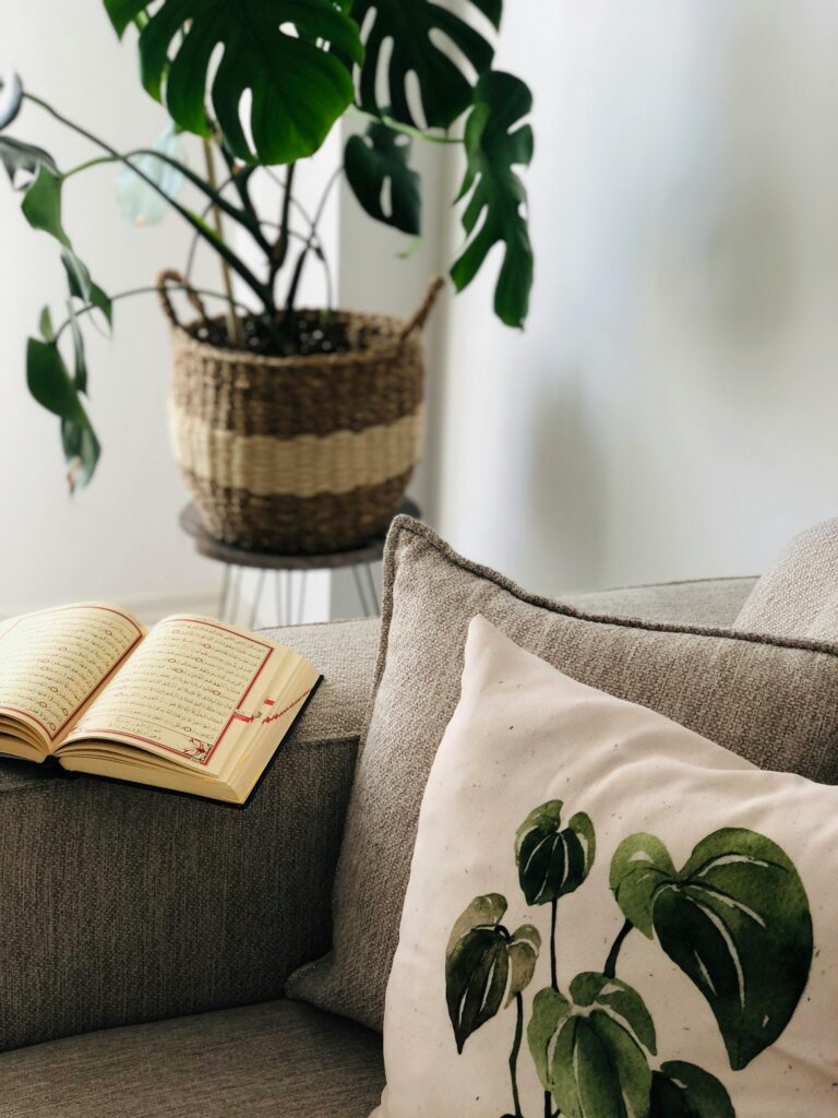 A cozy living space with a beige couch, decorative pillows, and an open book with Arabic script resting on it. Learn more about how individual therapy can offer support by searching for a culturally sensitive therapist in New York. An Asian therapist in California can offer support today.