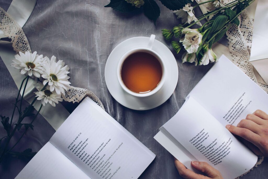 Shows a cup of tea on a table with poetry books. Represents how individual therapy in los angeles, ca with an asian american therapist in los angeles can help you explore your cultural identity.