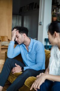 stressed woman working | burnout therapist in los angeles, ca | anxiety treatment in los angeles, ca | individual therapy in los angeles, ca | 90048 | 91502 Free A couple sitting indoors, showing emotional stress and tension during a quarrel. Stock Photo