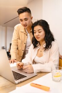 pexels-ai25studio-8374285 a man and woman smiling and looking at a computer screen together
