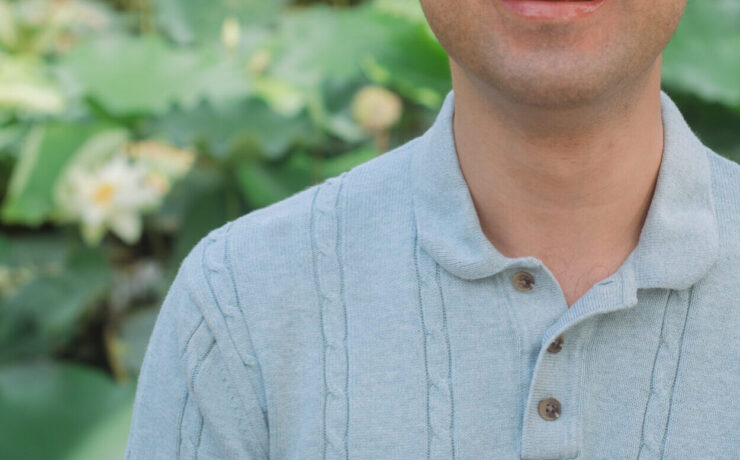 Smiling mixed-race therapist profile photo against a nature background